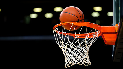 Dynamic Shot of a Basketball in Mid-Air, Entering the Net.