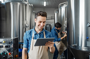 Family business, brewers working in craft beer brewery, control production. Smiling millennial...