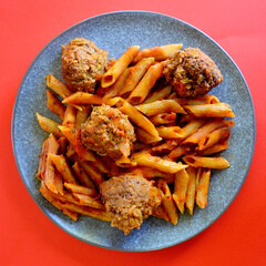 Tasty Italian style meatballs with penne pasta and tomato sauce. 