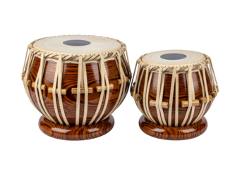 Two traditional Indian tabla drums, showcasing intricate wood grain patterns and beige straps, are displayed against a stark black backdrop.