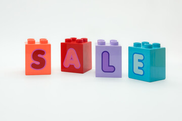 SALE alphabet on colorful building blocks isolated on a white background. Concept of toy, education, motivation, planning and hope