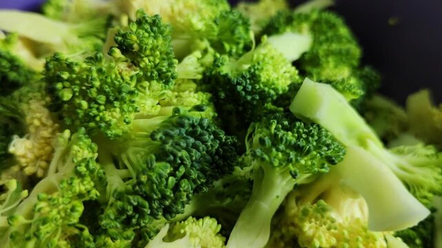 A detailed shot of fresh broccoli florets cut and prepared, highlighting the natural beauty of their green color and texture.