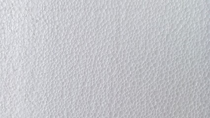 White expanded polystyrene foam sheet texture with a porous, bumpy surface, a versatile abstract...