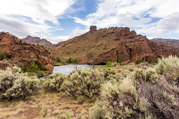 Unique rock formations over deserted area and a water stream