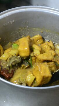 Traditional Indonesian Jenang Gula with Assorted Toppings Being Prepared in Home Kitchen