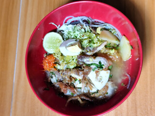 Soto Ayam in Indonesia. Soto ayam is a traditional Indonesian dish that uses ingredients such as shredded chicken, potatoes, eggs, vermicelli, bean sprouts with delicious sauce.