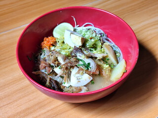 Soto Ayam in Indonesia. Soto ayam is a traditional Indonesian dish that uses ingredients such as shredded chicken, potatoes, eggs, vermicelli, bean sprouts with delicious sauce.