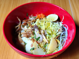 Soto Ayam in Indonesia. Soto ayam is a traditional Indonesian dish that uses ingredients such as shredded chicken, potatoes, eggs, vermicelli, bean sprouts with delicious sauce.