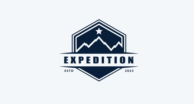 Dark blue hexagonal expedition badge logo with stylized mountains and star