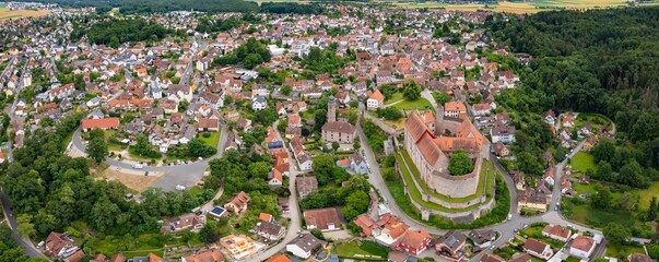 An aerial panorama view above the old town of the city Cadolzburg on a cloudy summer day in Bavaria, Germany