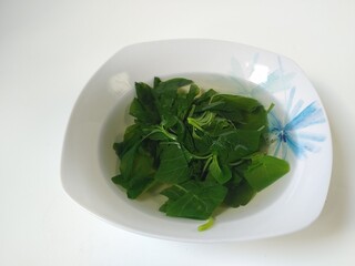 Sayur Bening Bayam or Spinach Clear Soup, isolated on white background 