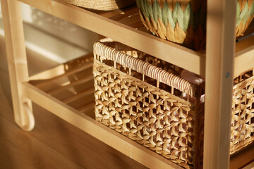 Beautifully arranged baskets on a wooden shelf in warm light