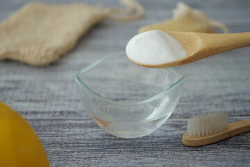 mixing baking soda powder with water for cleaning 