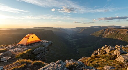 Tent on cliff edge overlooking mountain valley