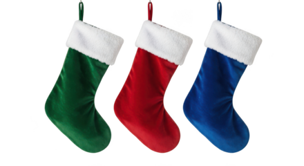 Three christmas stockings in green, red, and blue hanging isolated on transparent background