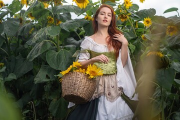 Redhead woman, vintage dress, and woven basket overflowing with sunflowers create a whimsical...