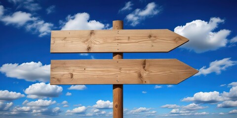 Fototapeta premium Wooden sign with arrows pointing upwards towards a clear blue sky