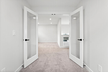 Large, open space with two doors leading to a room