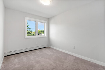 Very clean and empty bedroom with a window