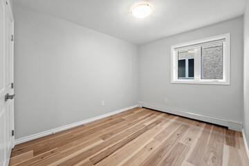 Fototapeta premium Very clean and empty room with a white wall and wooden floors