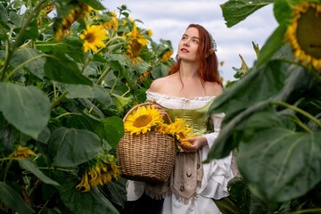 Redhead woman amidst sunflowers, basket overflowing with blooms, evokes whimsical fairytale charm.