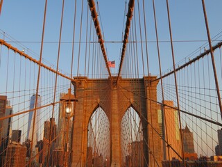 Fototapeta premium the view of a Brooklyn bridge with Manhattan skyline at dawn in summer