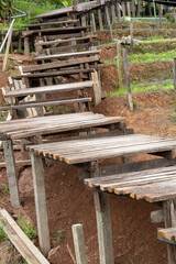 A rather old wooden staircase on a hillside in the countryside.