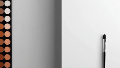 Makeup palette and brush on a gray and white background