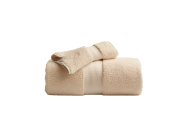 Soft cream-colored towels stacked neatly, perfect for a spa or home bathroom setting.
