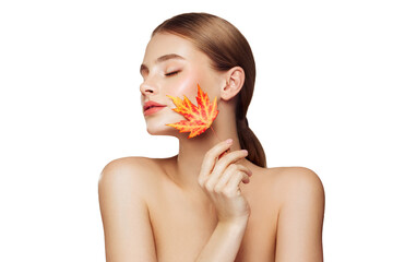 Portrait of beautiful young woman with autumn leafs. Healthy clean fresh skin natural make up beauty eyes