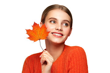 Portrait of beautiful young woman in orange blouse with autumn leafs. Healthy clean fresh skin...