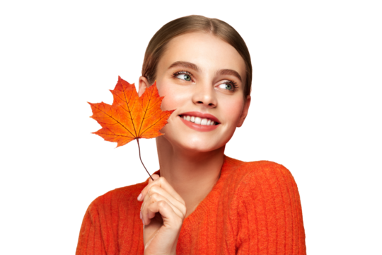 Portrait of beautiful young woman in orange blouse with autumn leafs. Healthy clean fresh skin natural make up beauty eyes