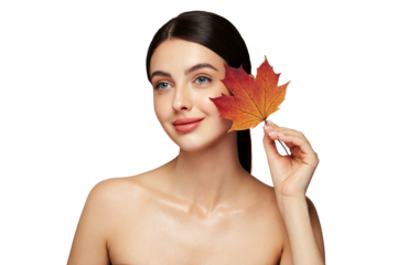 Portrait of beautiful young woman with autumn leafs. Healthy clean fresh skin natural make up beauty eyes
