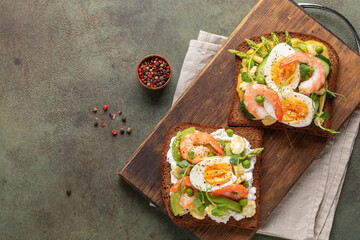 Homemade sandwiches with cheese cream, avocado, cucumbers, shrimp and eggs. Top view