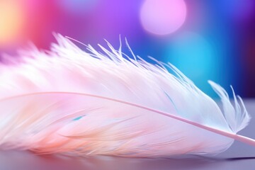 Fototapeta premium A white feather rests gracefully on a textured surface, surrounded by a mesmerizing bokeh of soft pastel hues and shimmering lights that create a magical atmosphere.