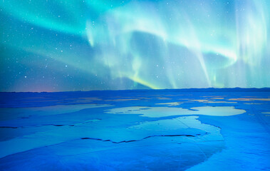 Beautiful winter landscape of frozen Lake Baikal with Aurora Borealis - Snowy ice hummocks with...