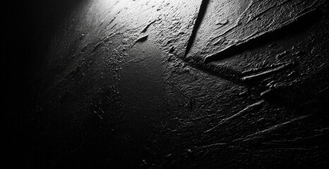 Dark, textured surface with light source