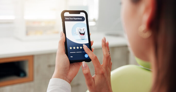 Hands, woman and phone screen in dentist office for consultation, inquiry and service reviews. Person, patient and mobile app for dental website, appointment survey and information for oral treatment - Powered by Adobe