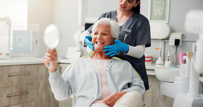 Dentist, senior woman and mirror with results for teeth whitening, dental implant or oral care. Retirement, healthcare and doctor with happy old patient in clinic for dentures or root canal treatment