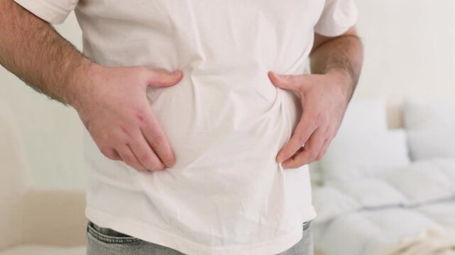 unrecognizable man grabbing his belly fat 4k video