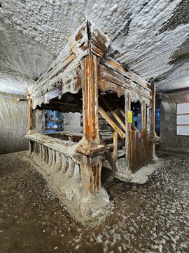 Beautiful staircase sculpted in fir wood and covered in salt deposits at Salina Turda salt mine. Cluj, Romania