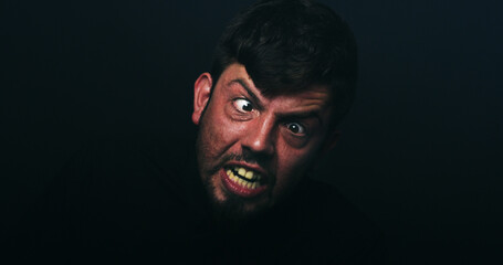 Upset, bipolar and man screaming in studio with schizophrenia, paranoid and panic reaction. Male...