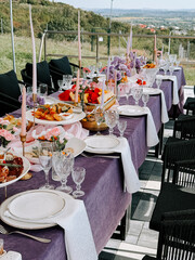 Elegant outdoor dining setup with colorful dishes and beautiful table decor