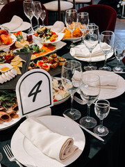 Elegant dining setting with diverse dishes and glassware at a stylish event venue