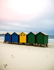 Colorful beach huts on a sandy shore