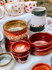 Handmade pottery collection displayed at a local artisan market in the afternoon sunlight