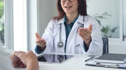 Female doctor and patient in appointment at doctor office with advice. Medical clinic, male patient...