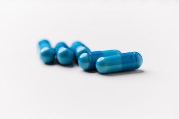 Amino acids capsules on bright background. Soft focus. Close up. Copy space.	