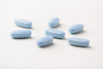 Multivitamin tablets on bright paper background. Close up. Copy space	