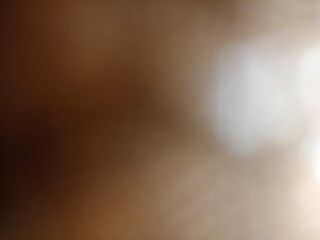 An abstract representation of warm light and shadow creating a sense of depth and mystery in a softly focused composition.